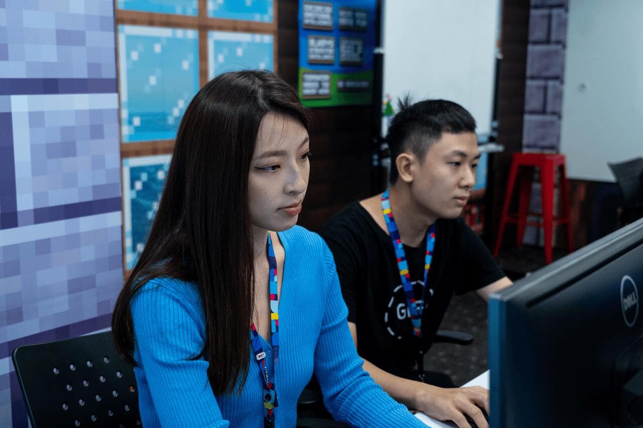 2 employees working at a desk with a computer