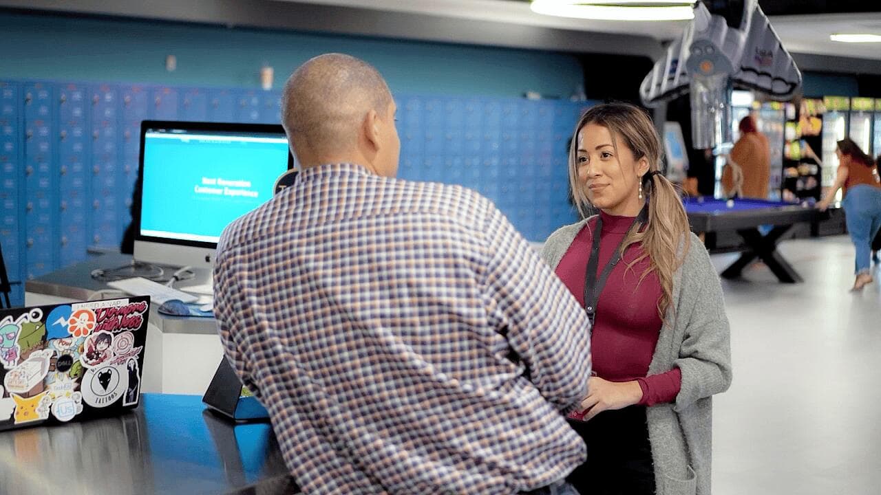 Two employees in discussion standing at a counter